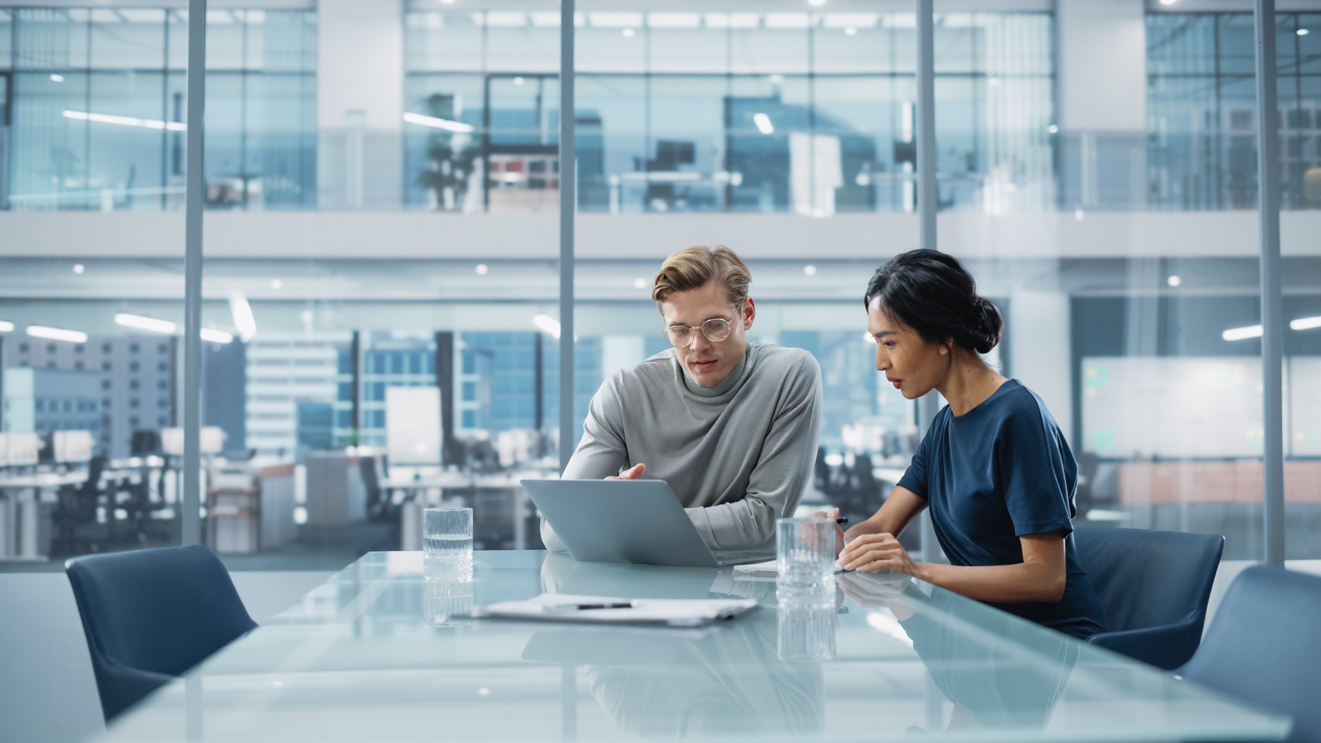 Multiethnic Diverse Office Conference Room Meeting: Team of Two Creative Entrepreneurs Talk, Discuss Growth Strategy. Stylish Young Businesspeople work on Investment and Marketing Projects.